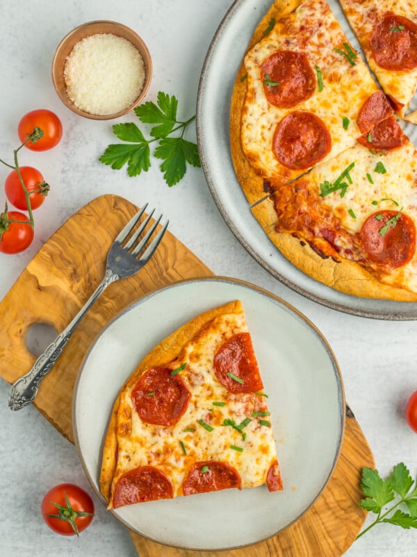 a grey plate with a tortilla pizza on a wooden board.