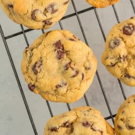 chocolate chip cookies on a wire baking rim.