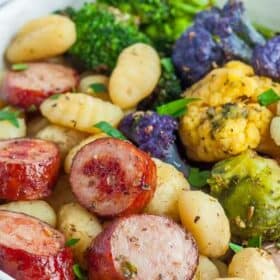 a bowl with roasted gnocchi, chicken sausage, and veggies.