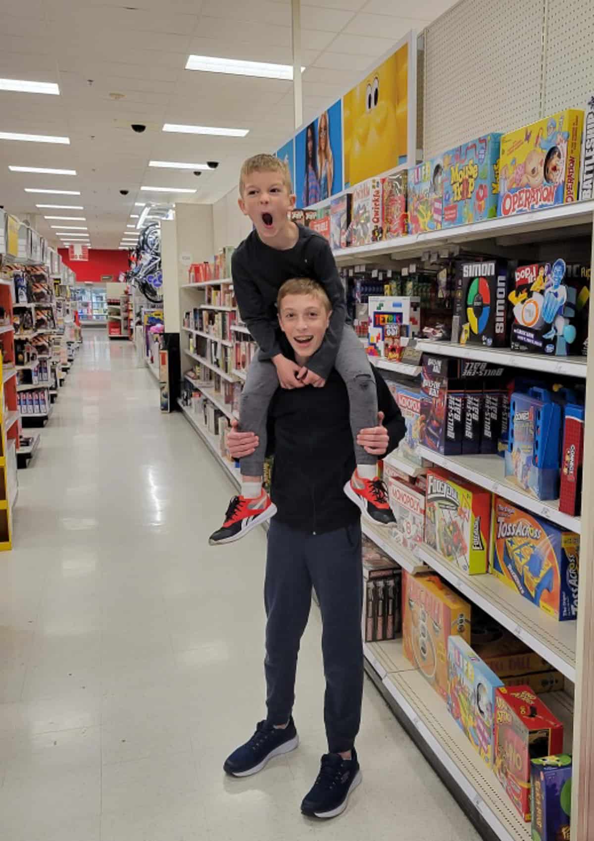 2 brothers, with one on the other's shoulders at Target.