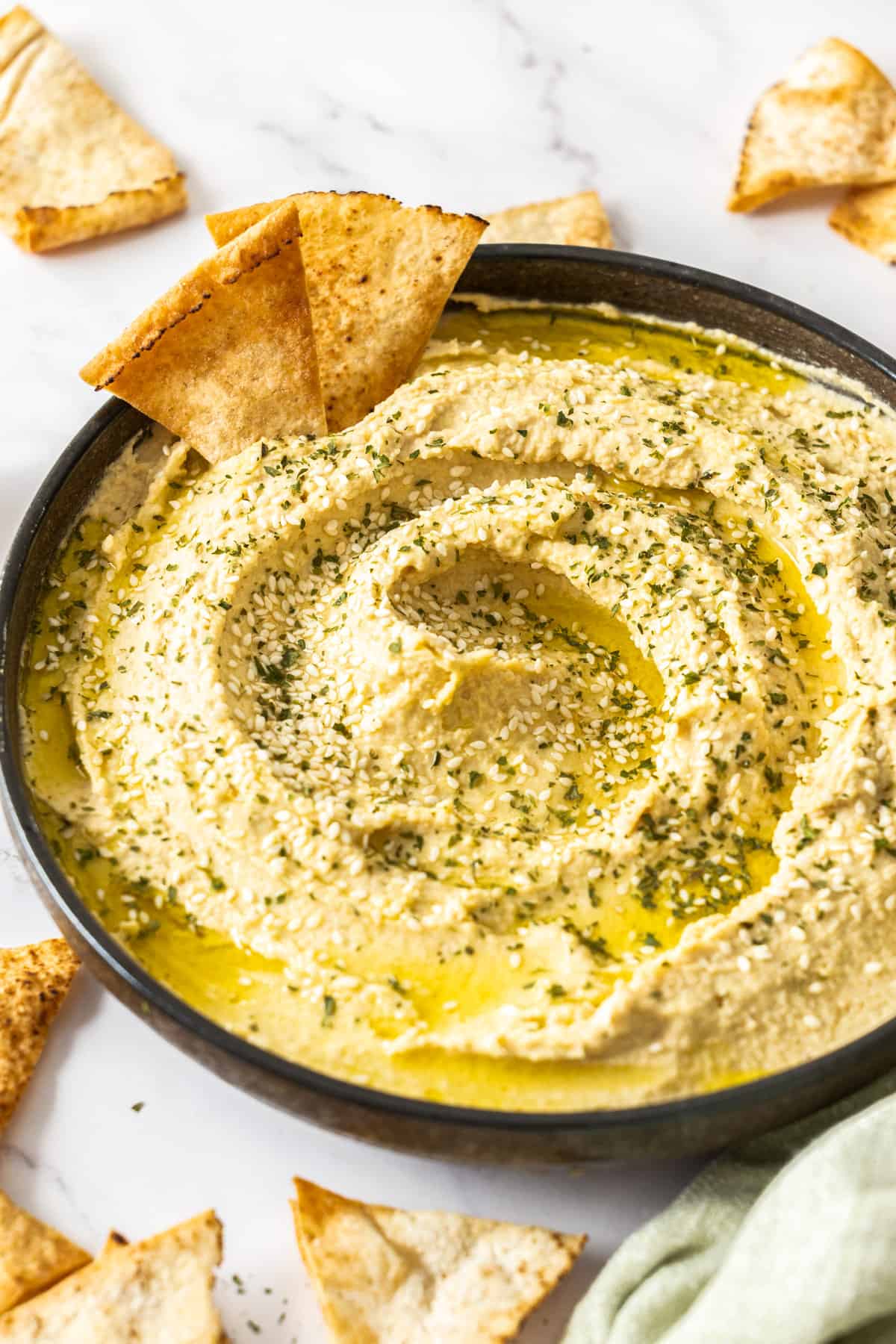 a bowl of chickpea dip with chips.