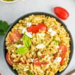 orzo salad in a blue bowl.