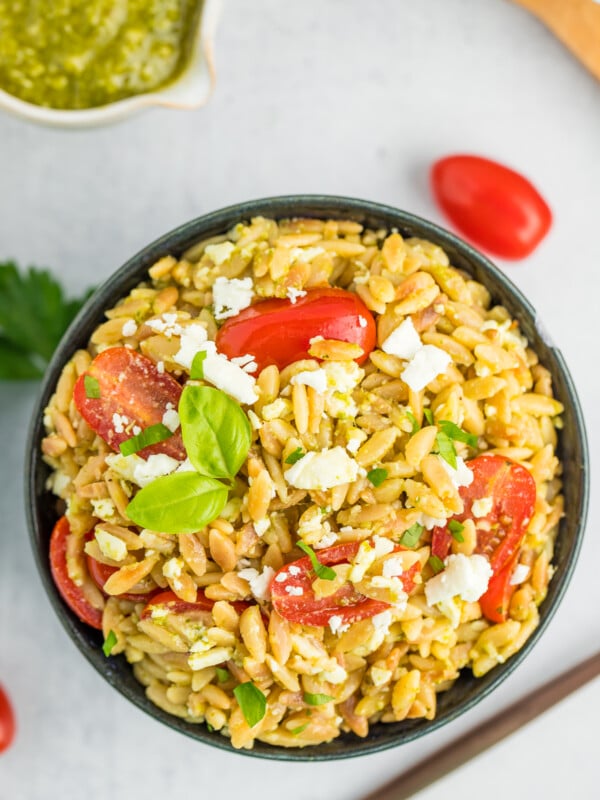 orzo salad in a blue bowl.