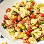 a cold pasta salad in a white bowl.