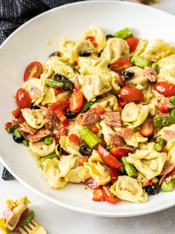 a cold pasta salad in a white bowl.