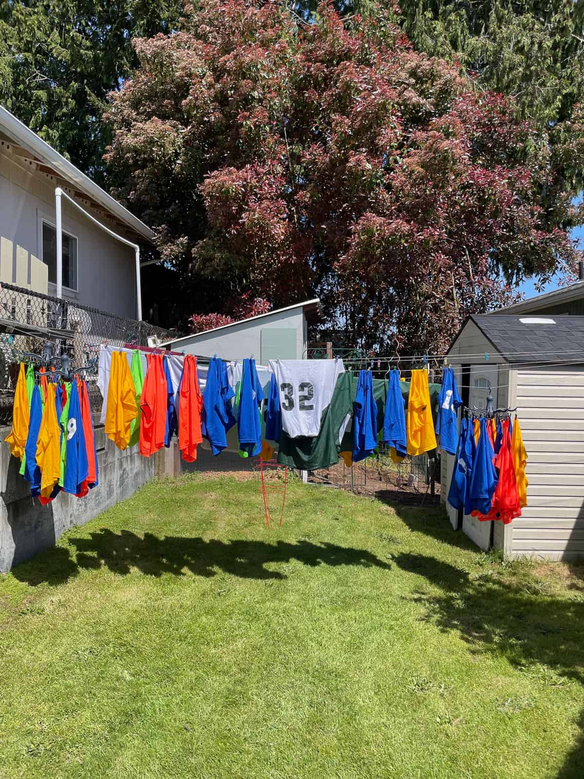 sports jerseys on a clothesline in the sun.