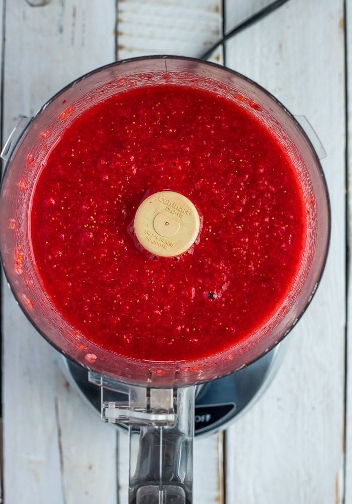 a food process with strawberry puree in it.