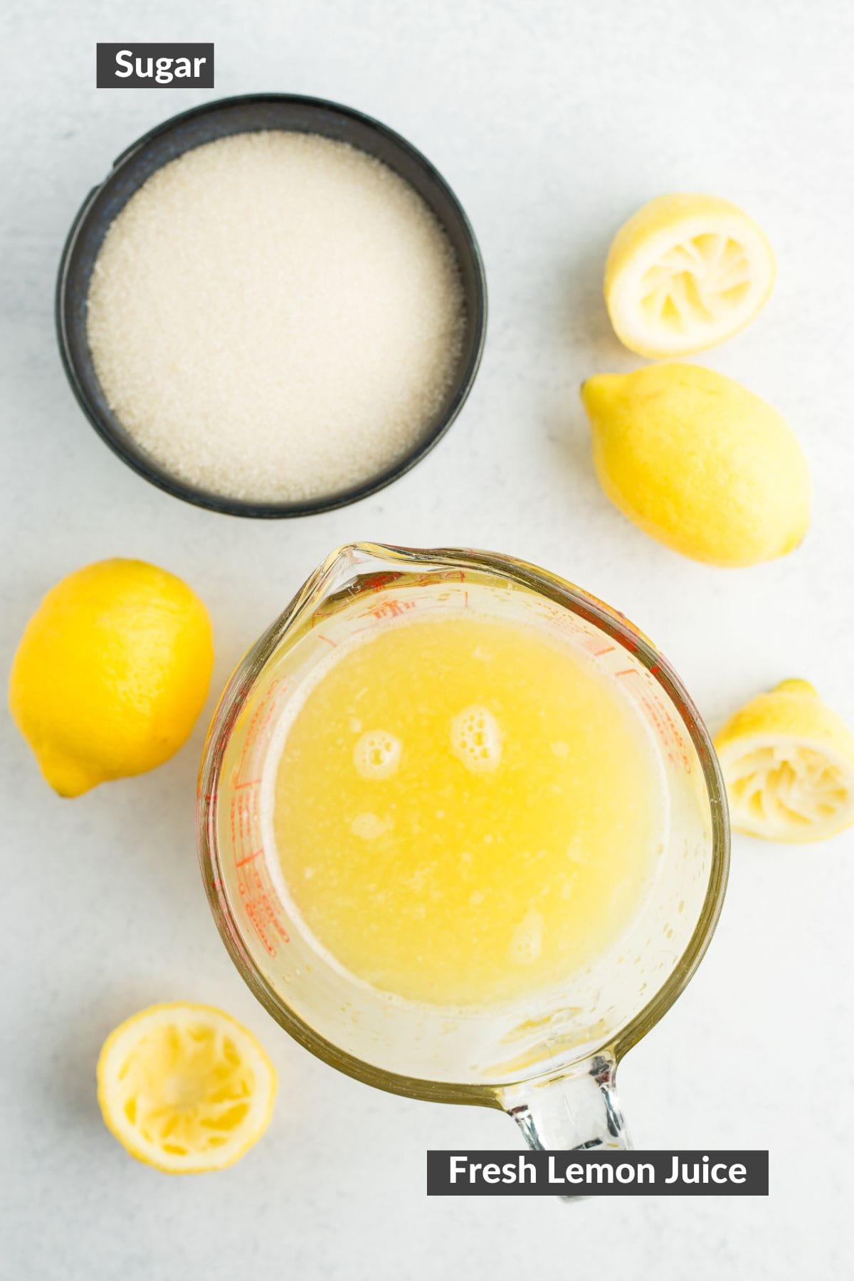 lemons and sugar on a grey board.
