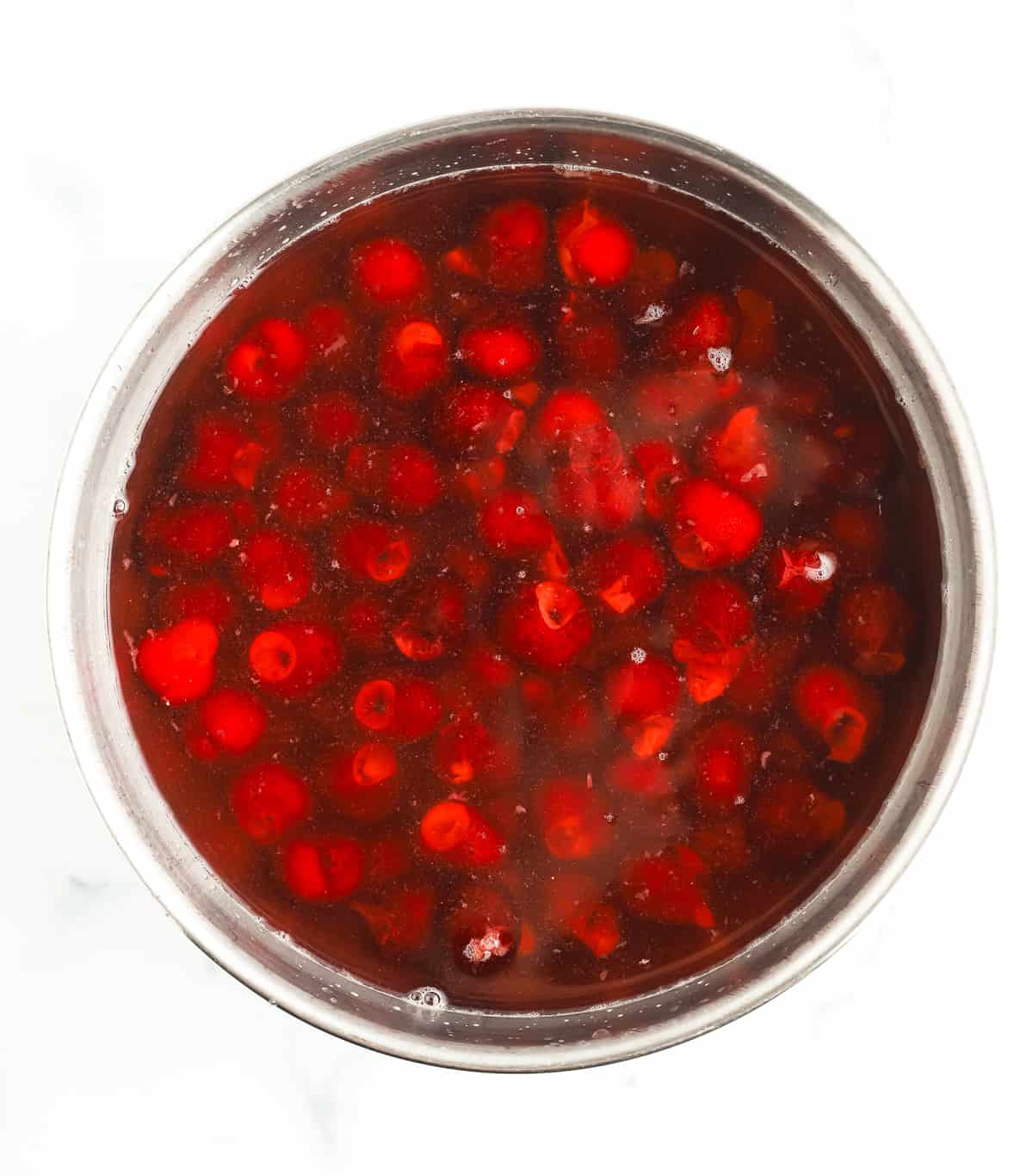 a bowl of pitted cherries in water