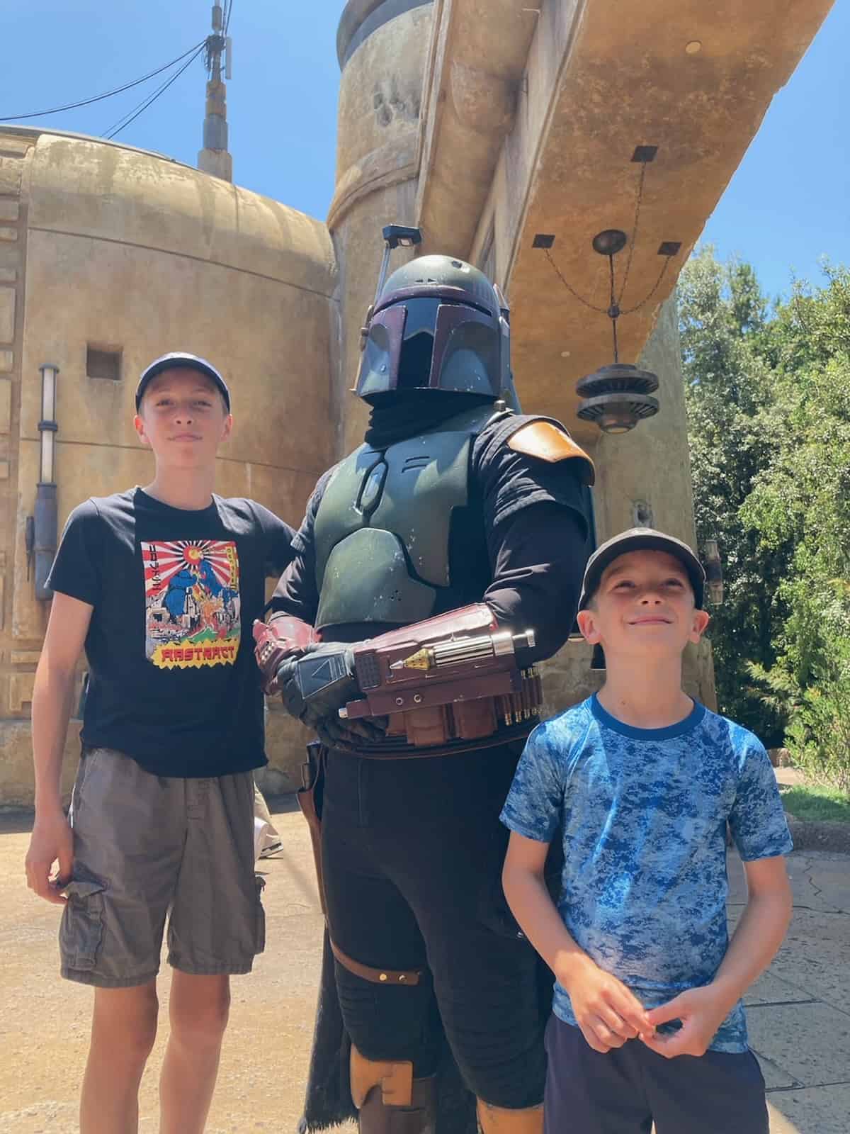 two kids at Disneyland with Boba Fett.