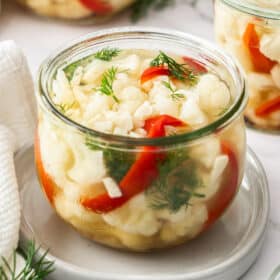 a weck jar of pickled cauliflower, red peppers, and dill.