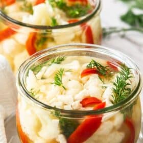a weck jar of pickled cauliflower, red peppers, and dill.