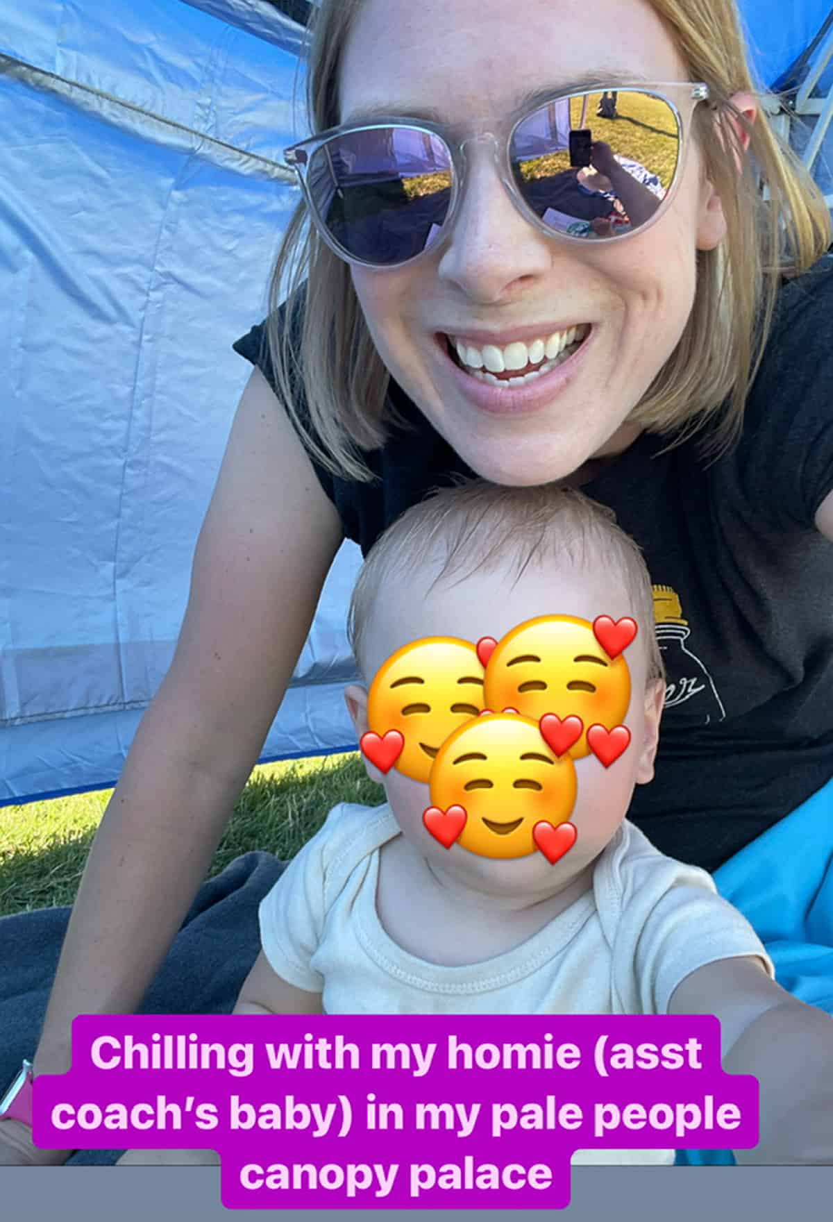 a woman with a baby with emoji over his face.