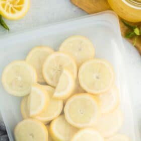 a silicone bag with frozen lemons and a glass of lemonade.