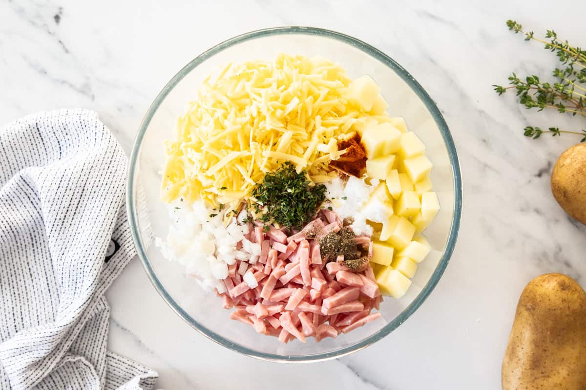 a bowl of ham, cheese, potatoes, and other ingredients.