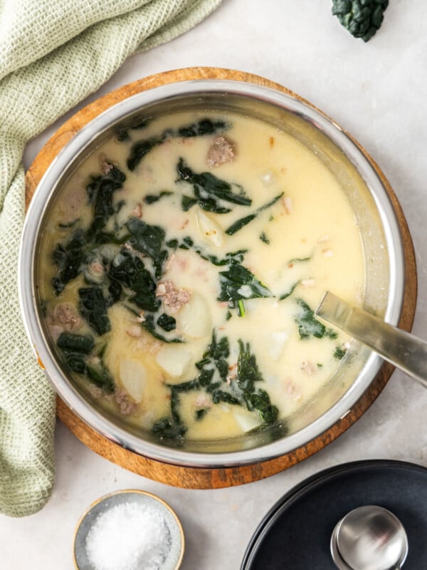 zuppa toscana in an Instant Pot with bowls and a ladle.