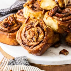 A dish stacked with pecan rolls.