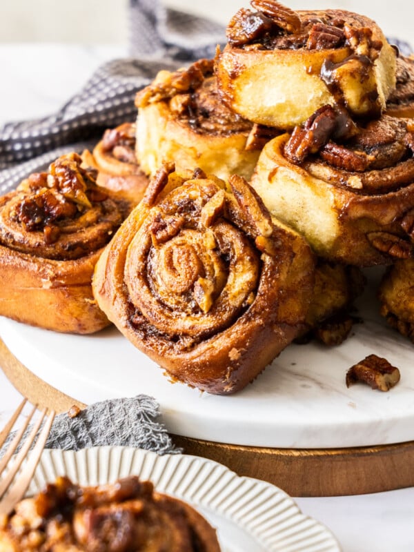 A dish stacked with pecan rolls.