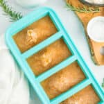 a teal freezer tray with frozen gravy.