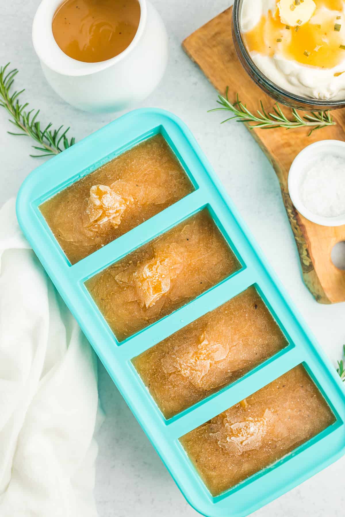 a teal freezer tray with frozen gravy.