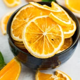 dehydrated orange slices in a blue bowl.