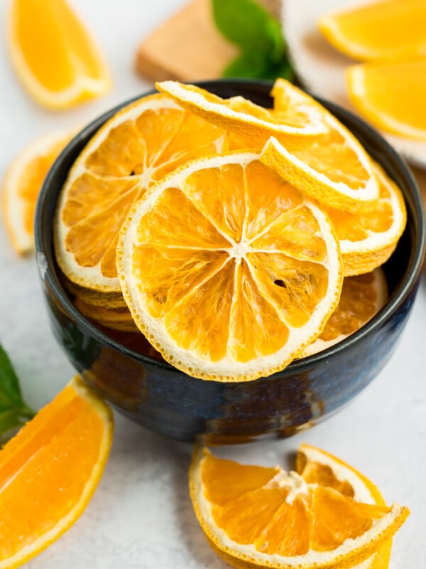 dehydrated orange slices in a blue bowl.