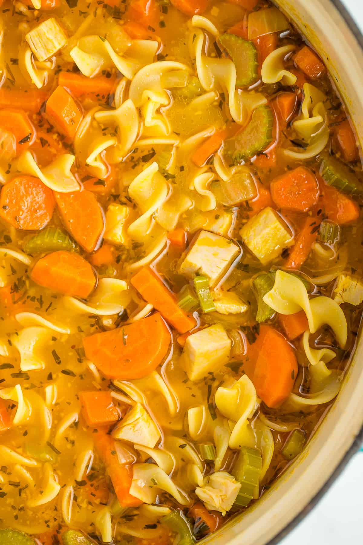 a large cast iron stockpot with turkey vegetable soup.