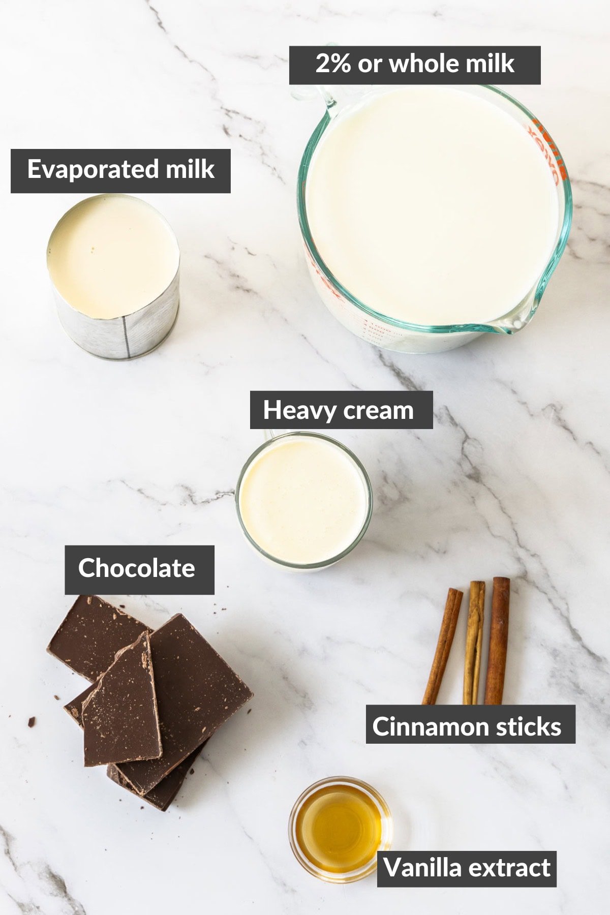 milk, cream, vanilla, and chocolate on a marbled board.