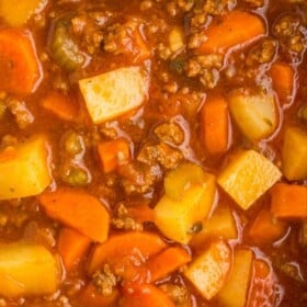 a dutch oven full of ground beef and vegetable soup.