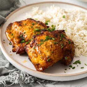 air fryer boneless chicken thighs on a bed of rice.