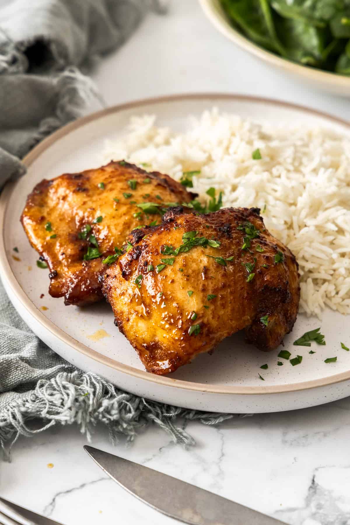 air fryer boneless chicken thighs on a bed of rice.