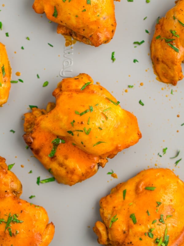 buffalo chicken thighs on a sheet pan.