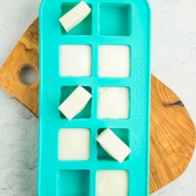 frozen cubes of buttermilk in a teal silicone tray.