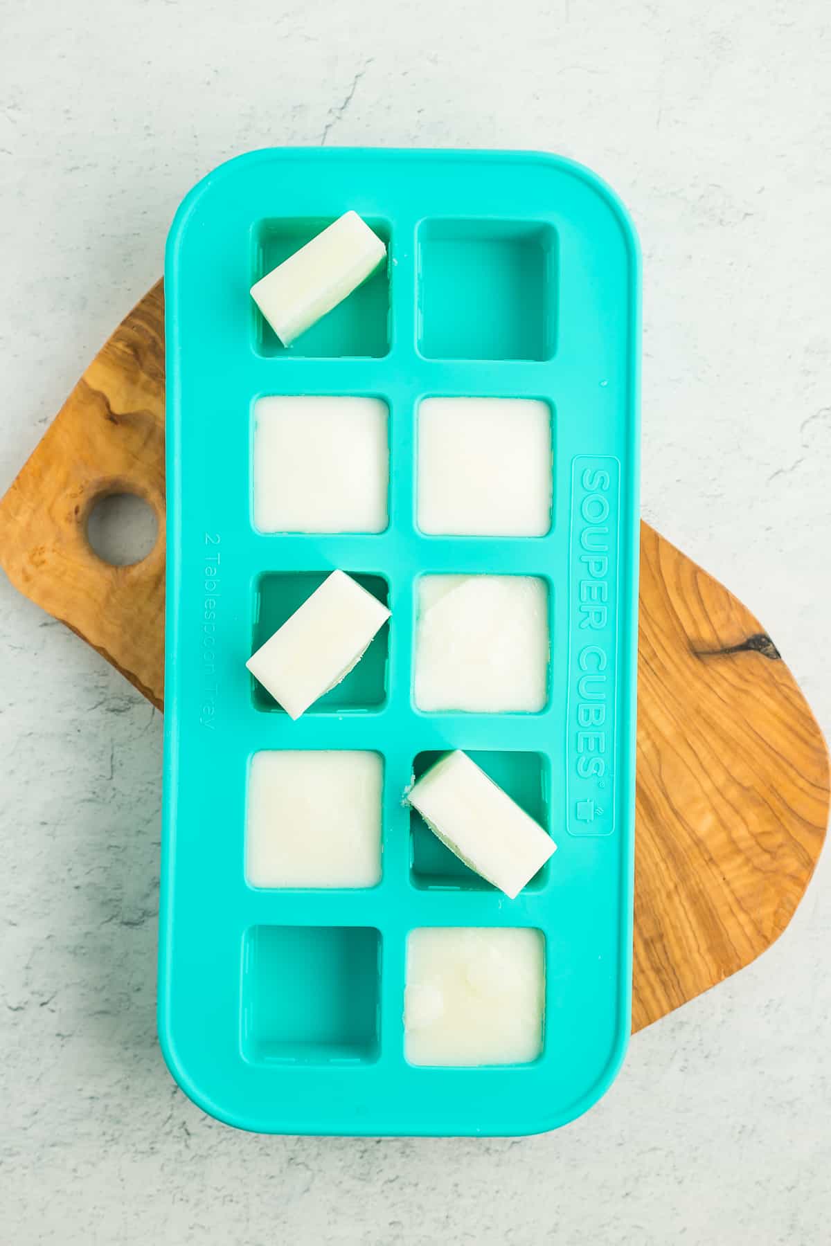 frozen cubes of buttermilk in a teal silicone tray.