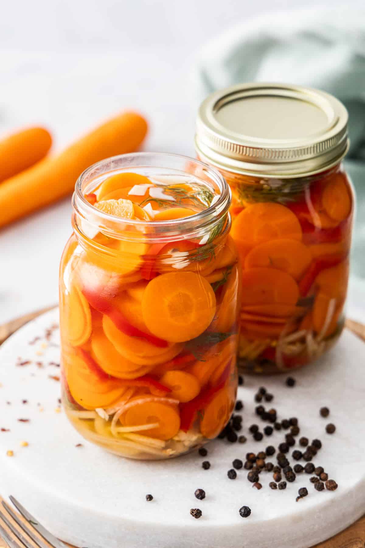 Two jars of sliced carrots in brine.