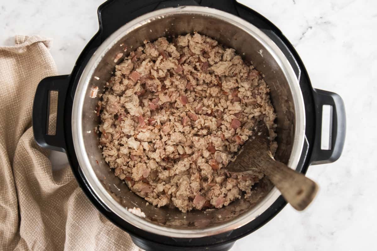 diced bacon and ground turkey being cooked in an Instant Pot.