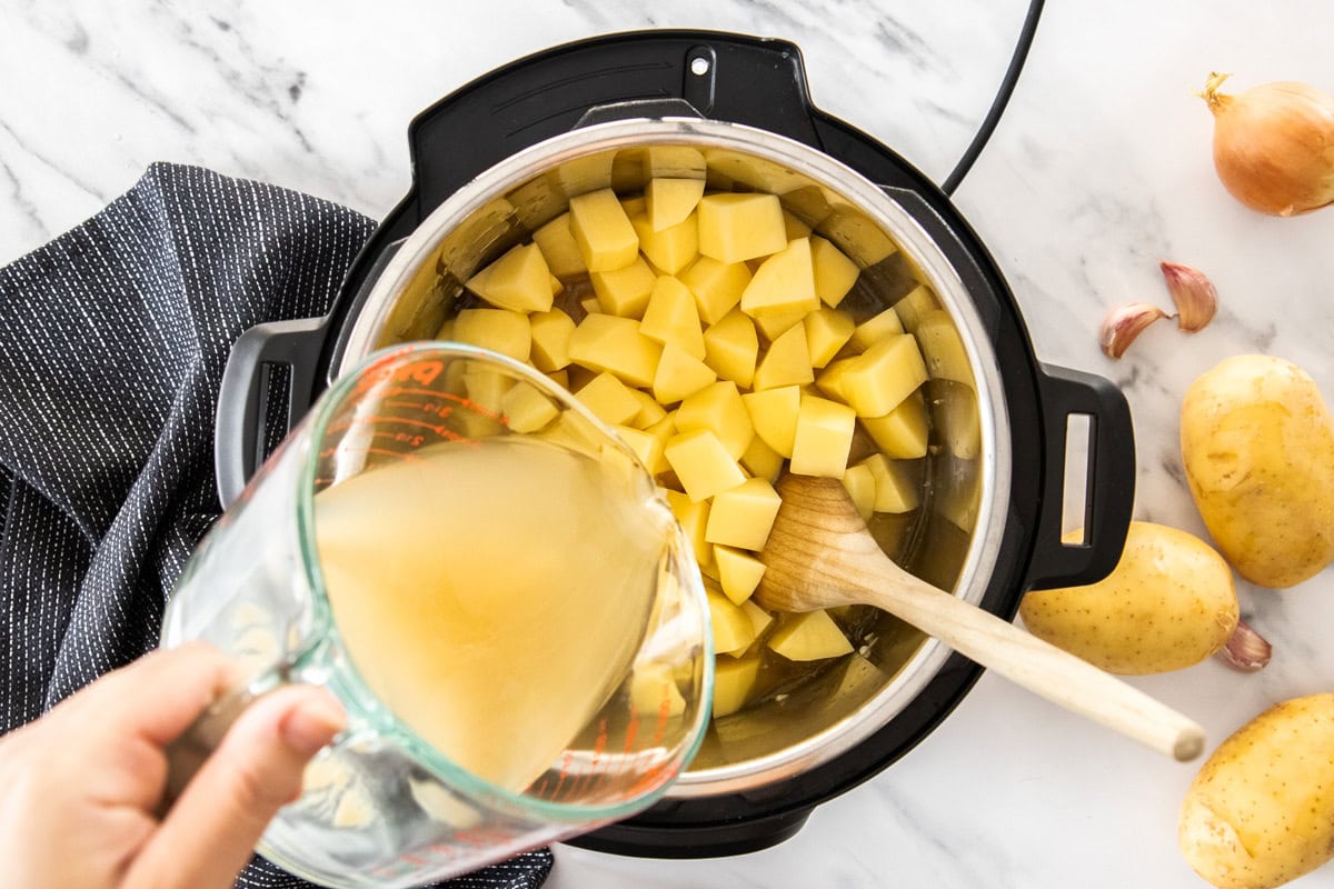 broth being poured into an Instant Pot.