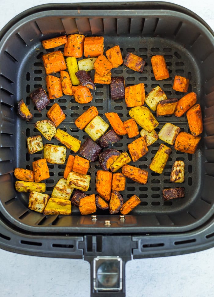 chopped carrots in an air fryer basket.