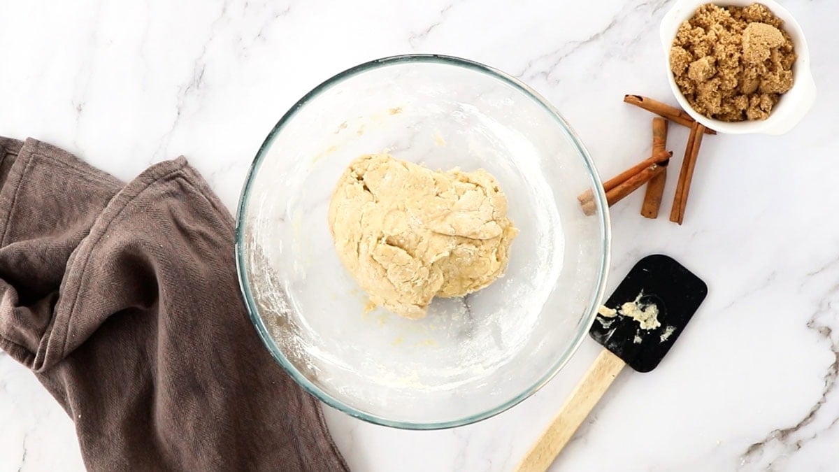 a ball of dough in a glass bowl.