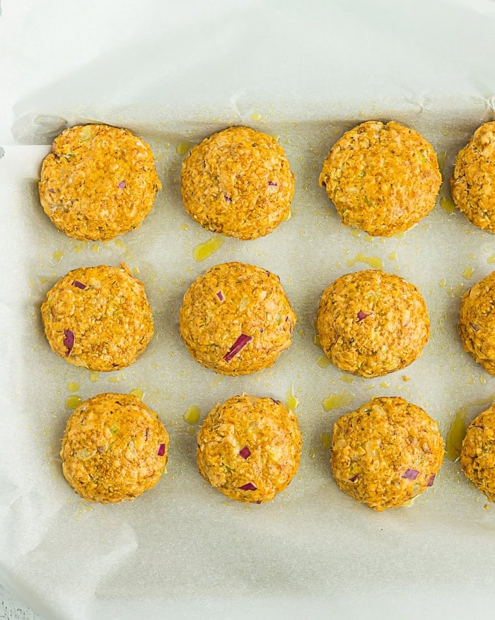 uncooked salmon cakes on a baking sheet lined with parchment.