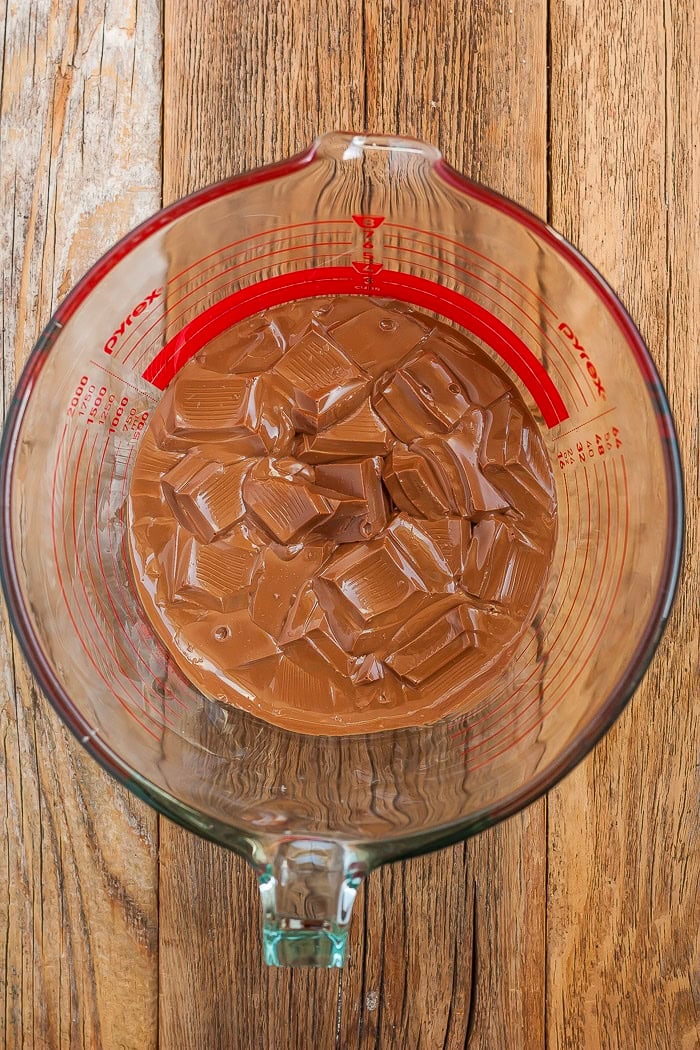 a glass bowl of partially melted chocolate.