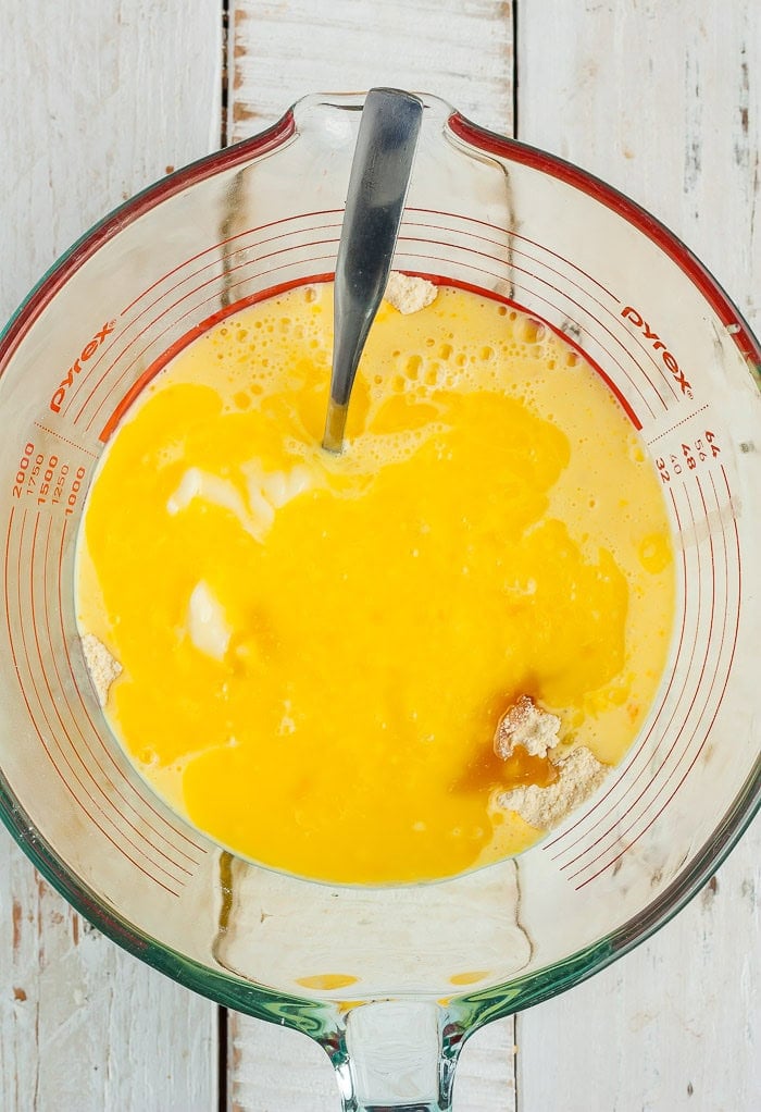 melted butter in a glass bowl with a spoon.