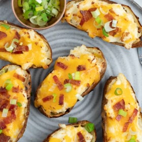 a grey plate with air fryer twice baked potatoes on it.