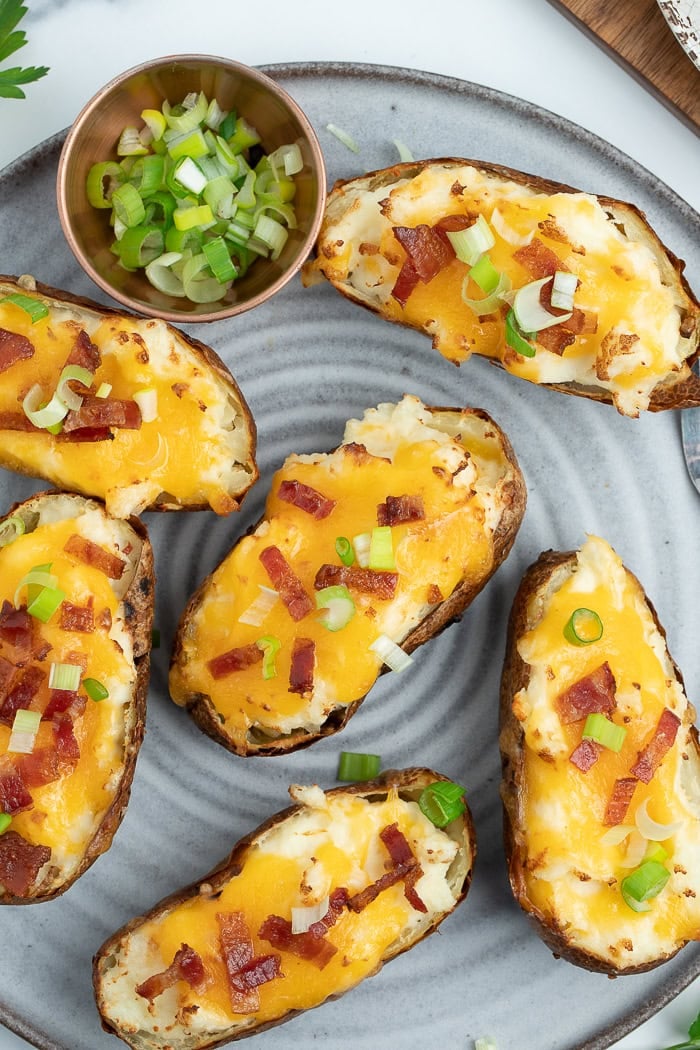 a grey plate with air fryer twice baked potatoes on it.