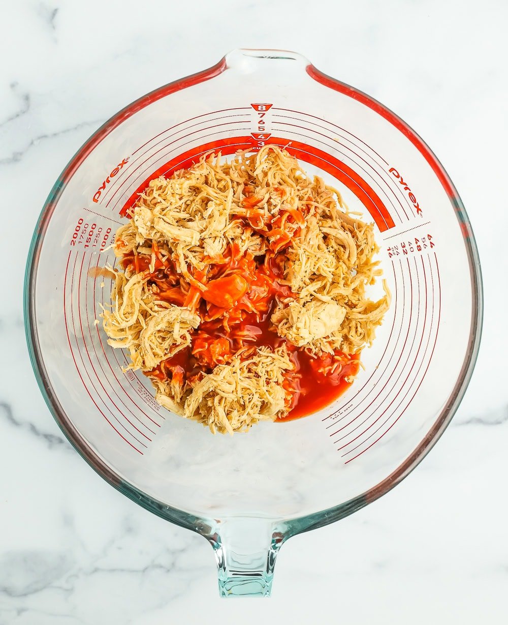 a bowl with mixed shredded chicken.