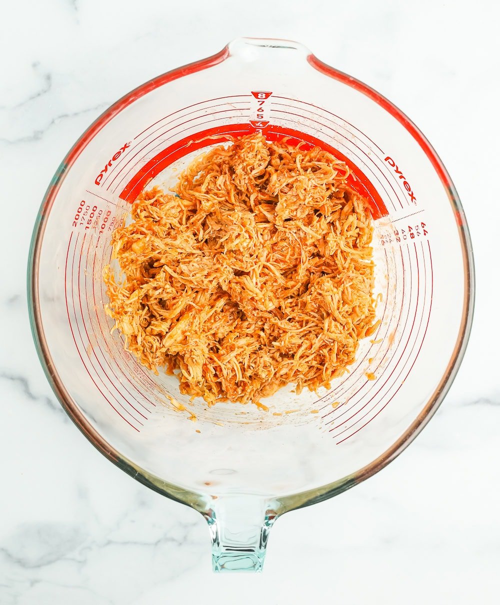 a bowl with mixed shredded chicken.