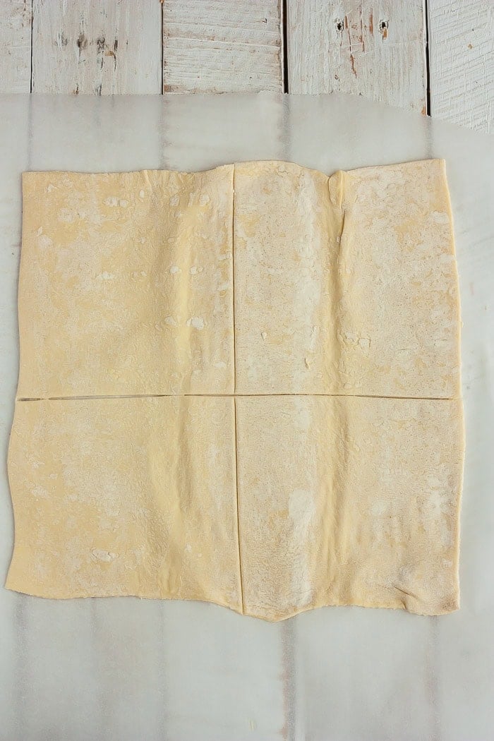 uncooked dough on a white wooden board.