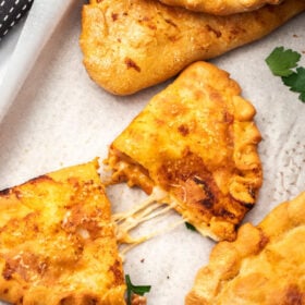 calzones on a baking sheet.