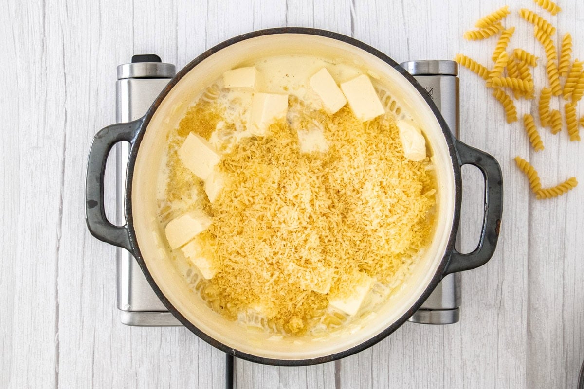 cheese and cubes of cream cheese in a Dutch oven.