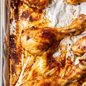 chicken legs on a sheet pan with foil.